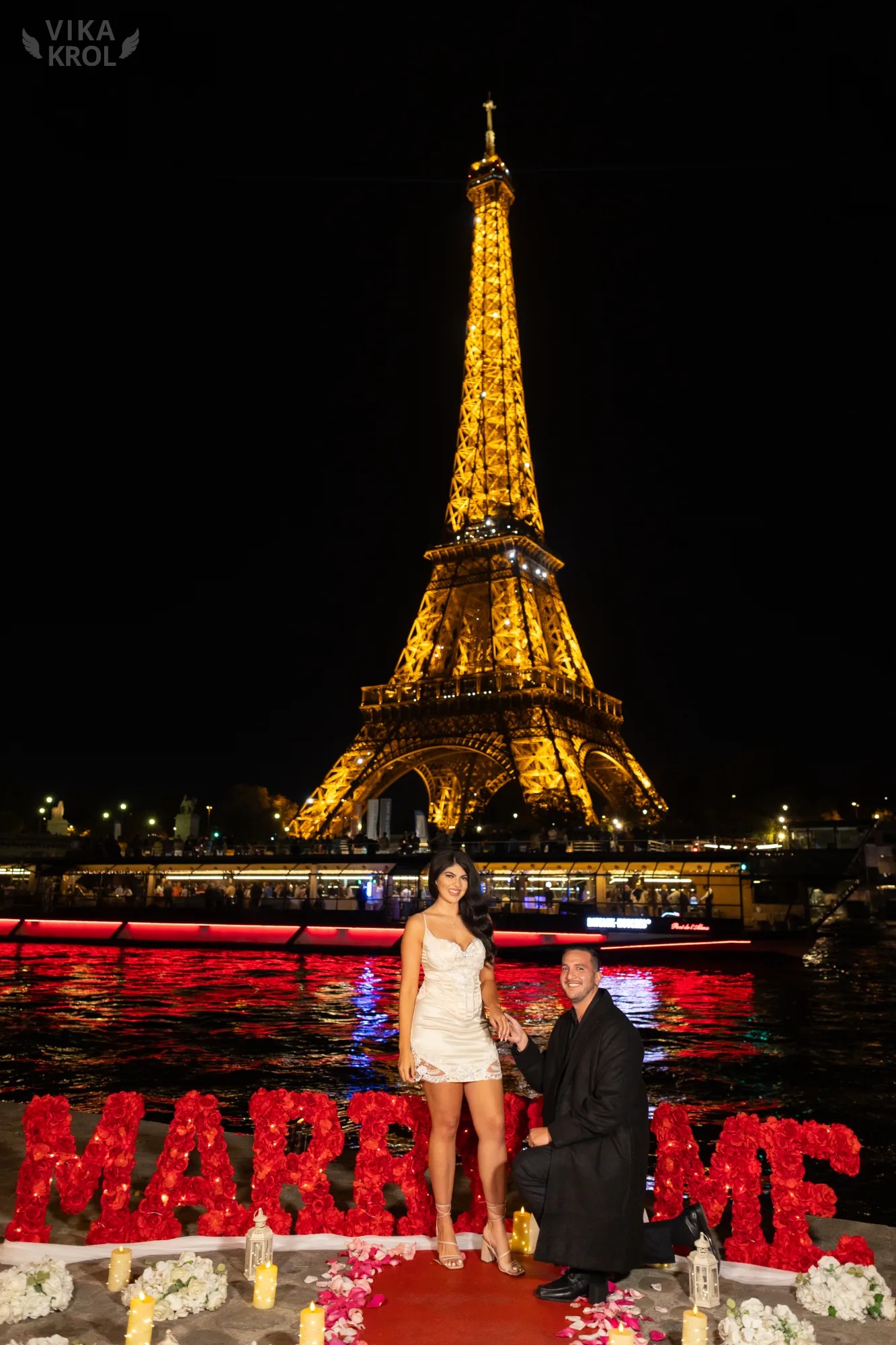 A wide-angle shot of a couple walking from a busy Parisian street into a quiet, narrow stone alleyway, showing the contrast in lighting and atmosphere.